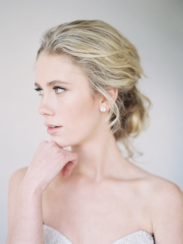 Closeup of Colorado bride with makeup and soft, messy updo hairstyle by Beauty on Location Studio of Denver